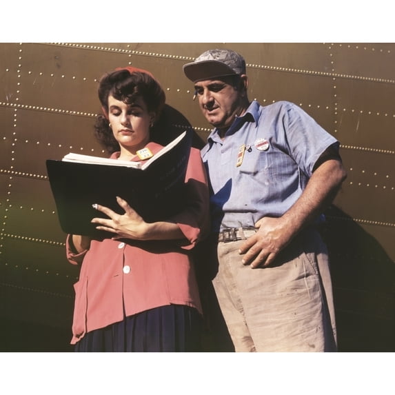 Female Inspector Confers With A Co-Worker When Checking The Center Wings For C-47 Transport Planes. During World War 2