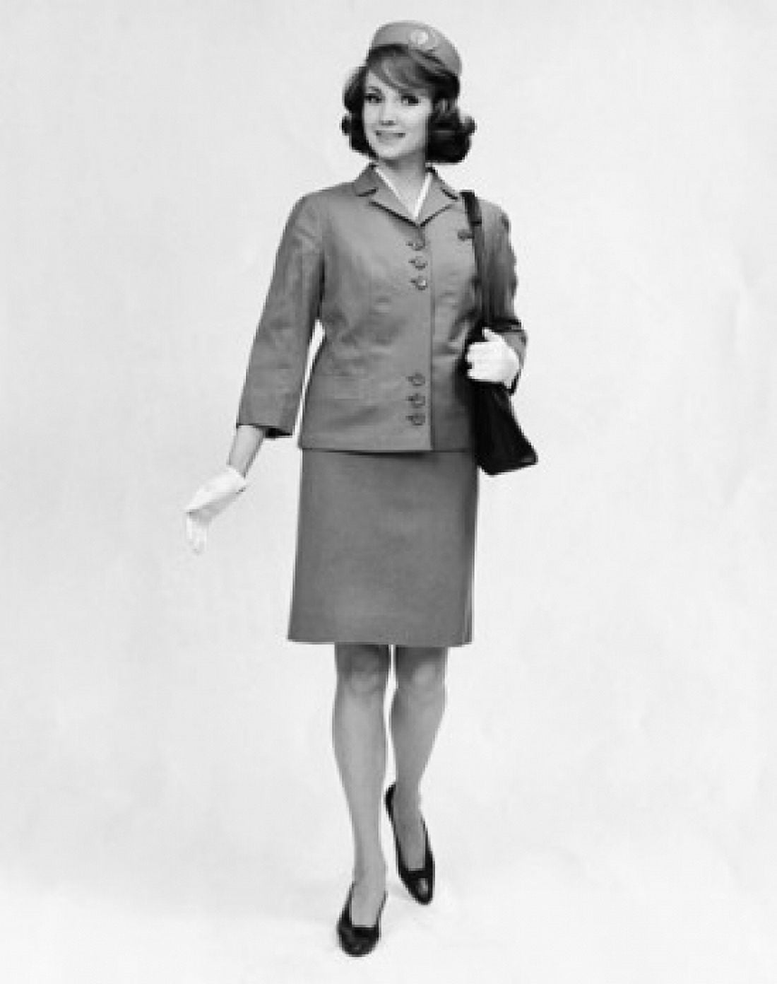 Female cabin crew carrying a hand bag and smiling Canvas Art - (18 x 24)
