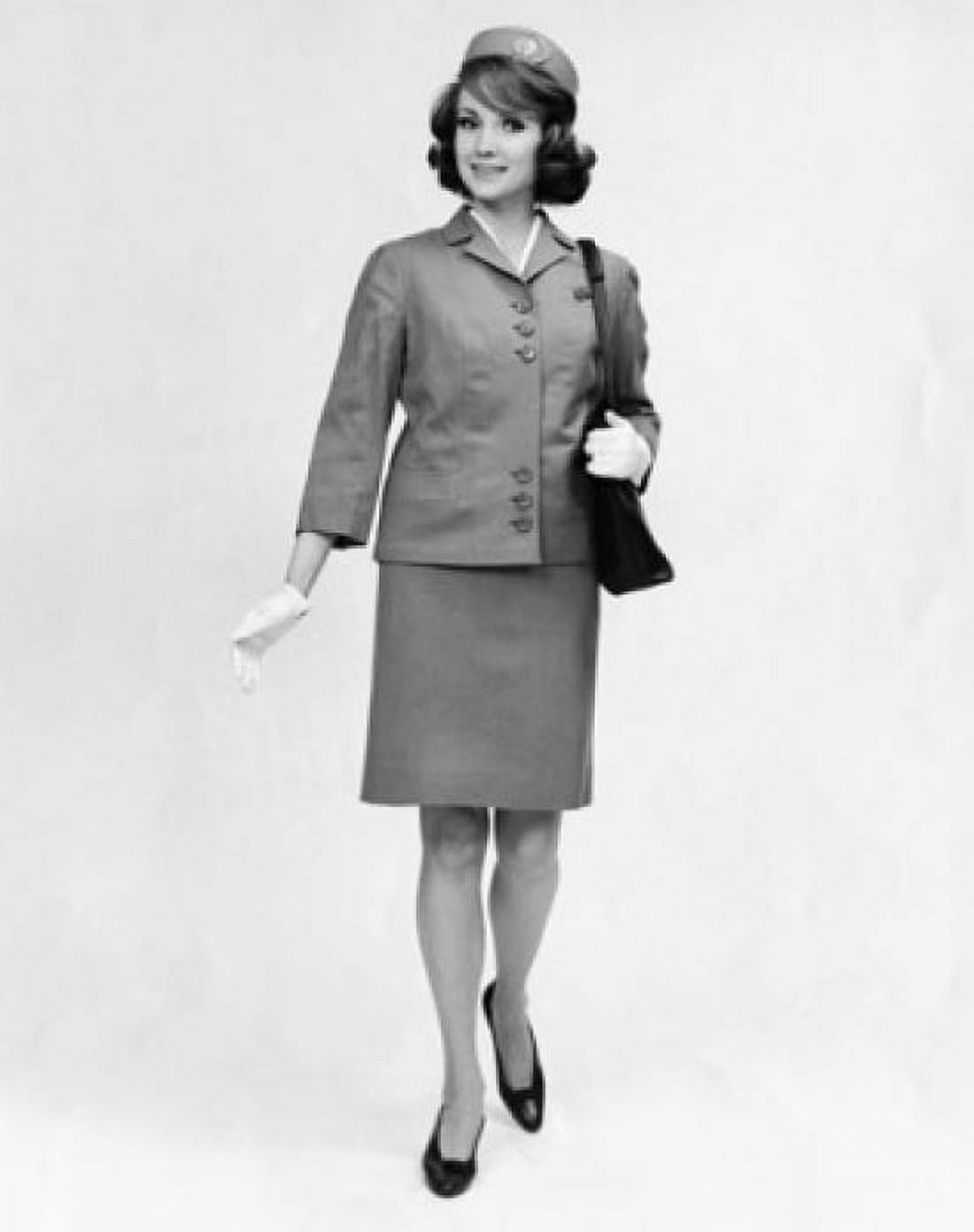 Female cabin crew carrying a hand bag and smiling Canvas Art - (24 x 36)