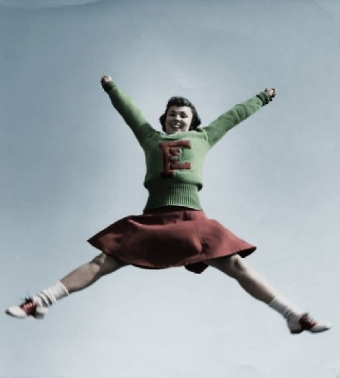 Female cheerleader jumping in air Canvas Art - (24 x 36)