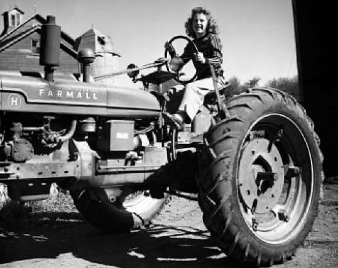 Female farmer sitting on a tractor Canvas Art - (18 x 24)