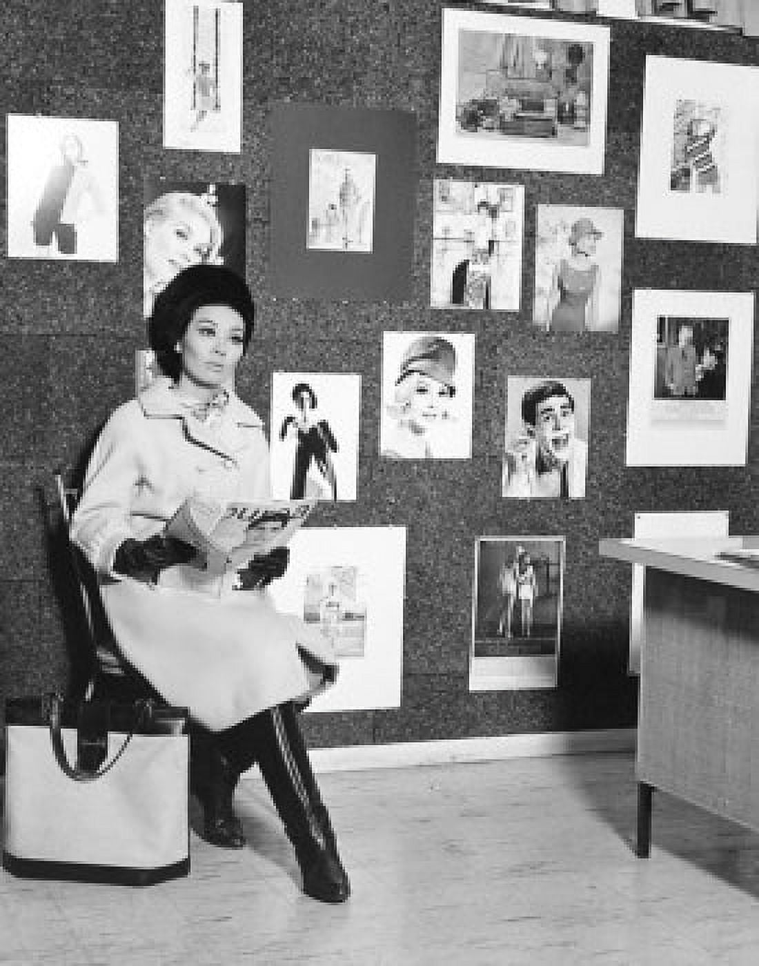 Female fashion model sitting in a chair and holding a magazine Canvas Art - (18 x 24)