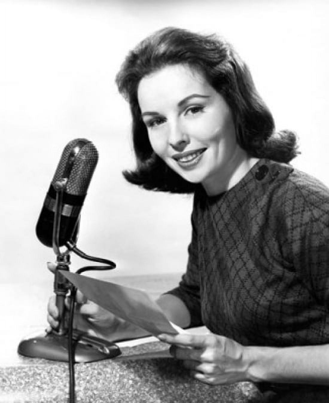 Female newscaster holding a microphone and a paper Canvas Art - (18 x 24)