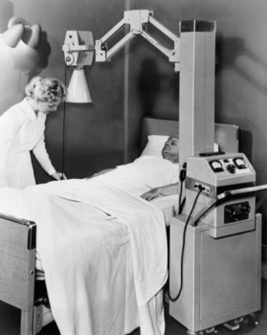 Female nurse adjusting the sheet of a patient in an X-Ray room Canvas Art - (18 x 24)