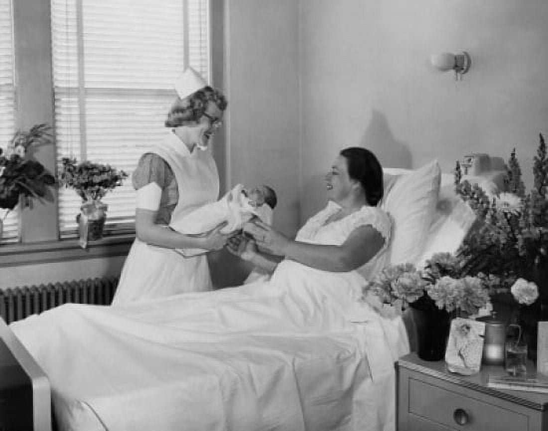 Female nurse giving a newborn baby to a young woman lying in a hospital bed Canvas Art - (18 x 24)