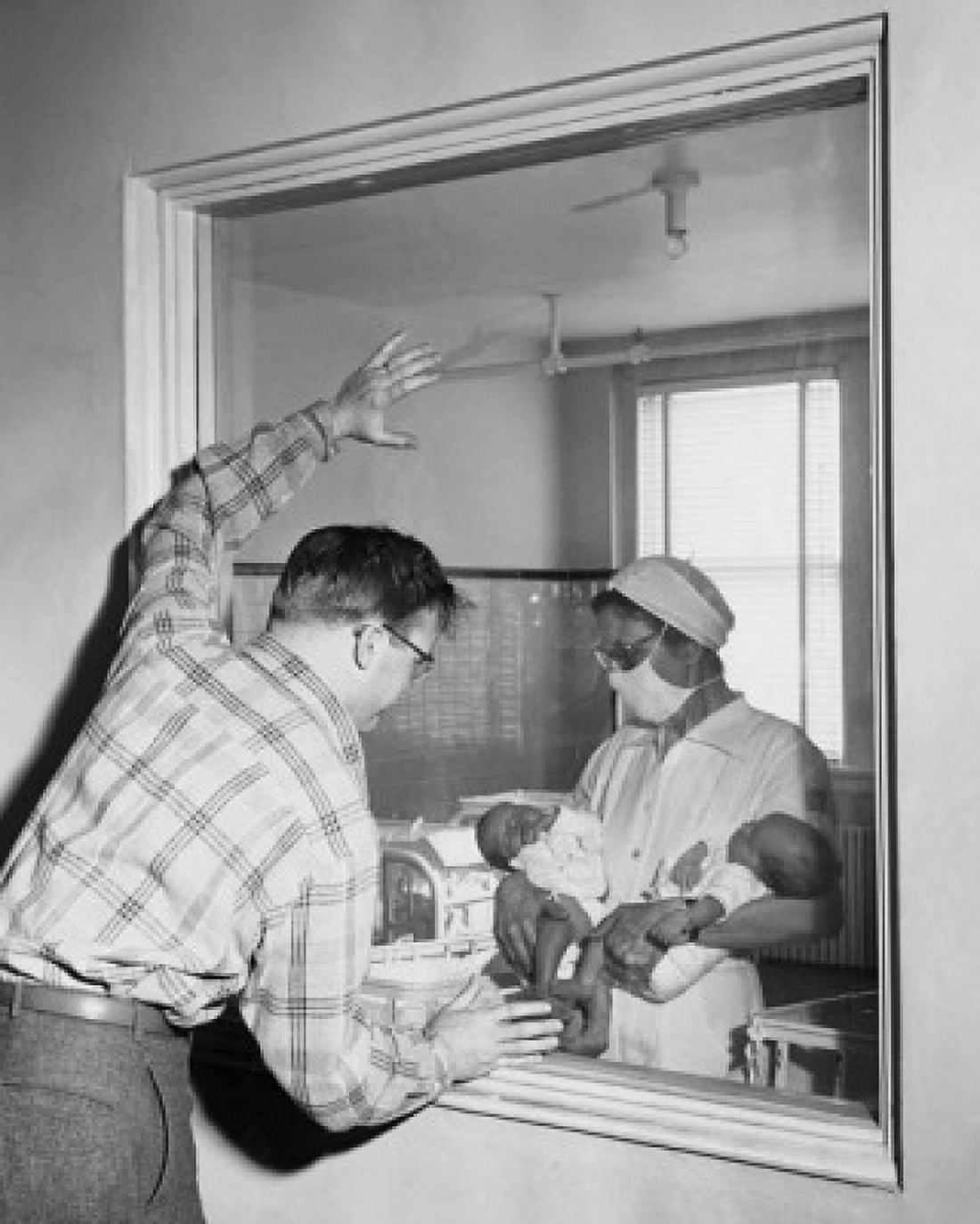 Female nurse showing two newborn babies to a mid adult man Canvas Art - (18 x 24)