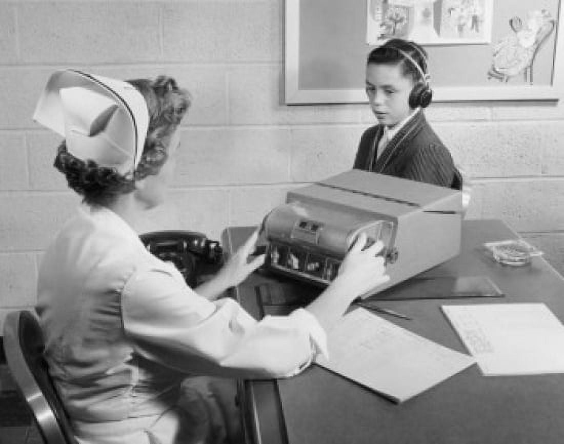 Female nurse taking hearing test of boy Canvas Art - (24 x 36)