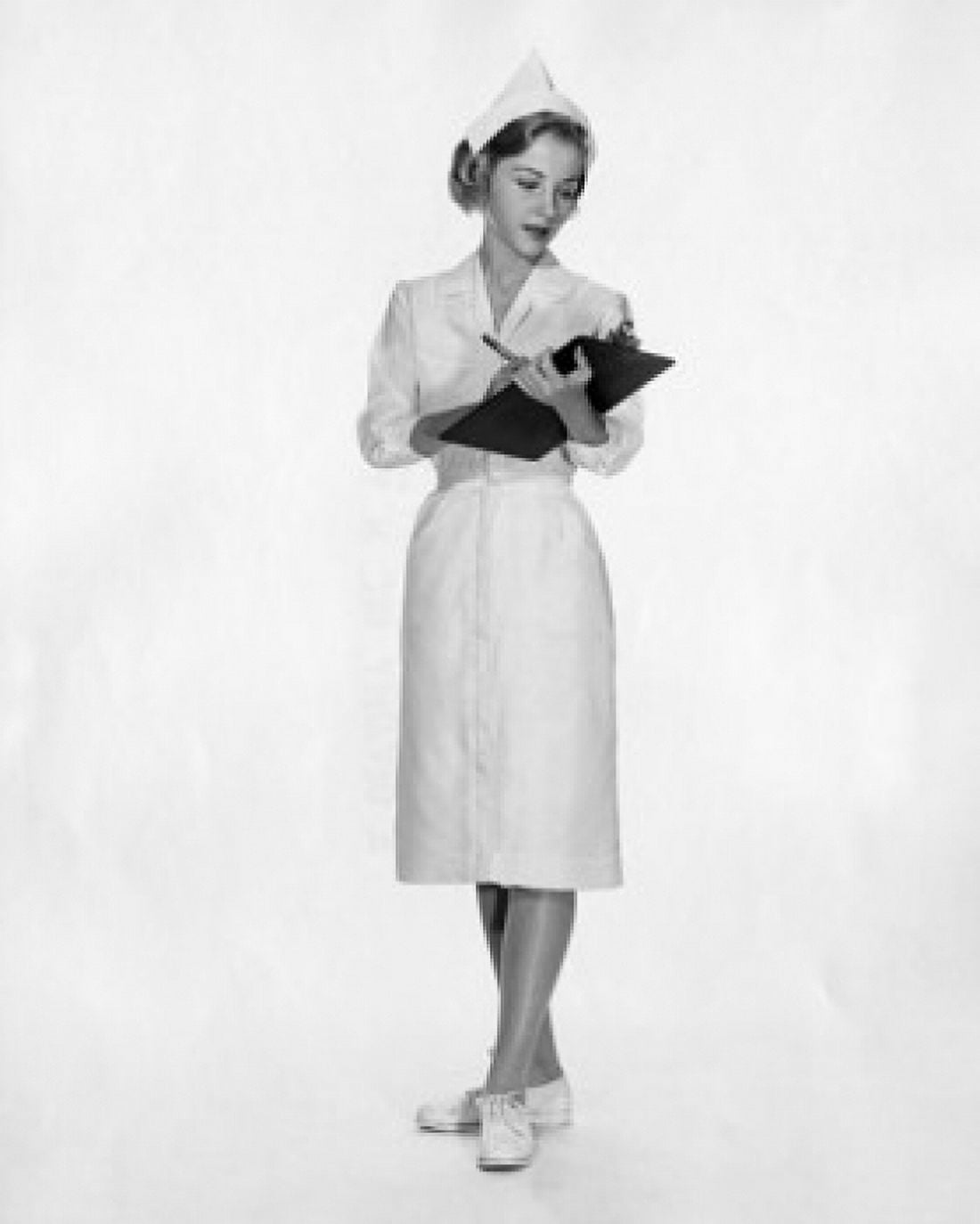Female nurse writing on a clipboard Canvas Art - (24 x 36)