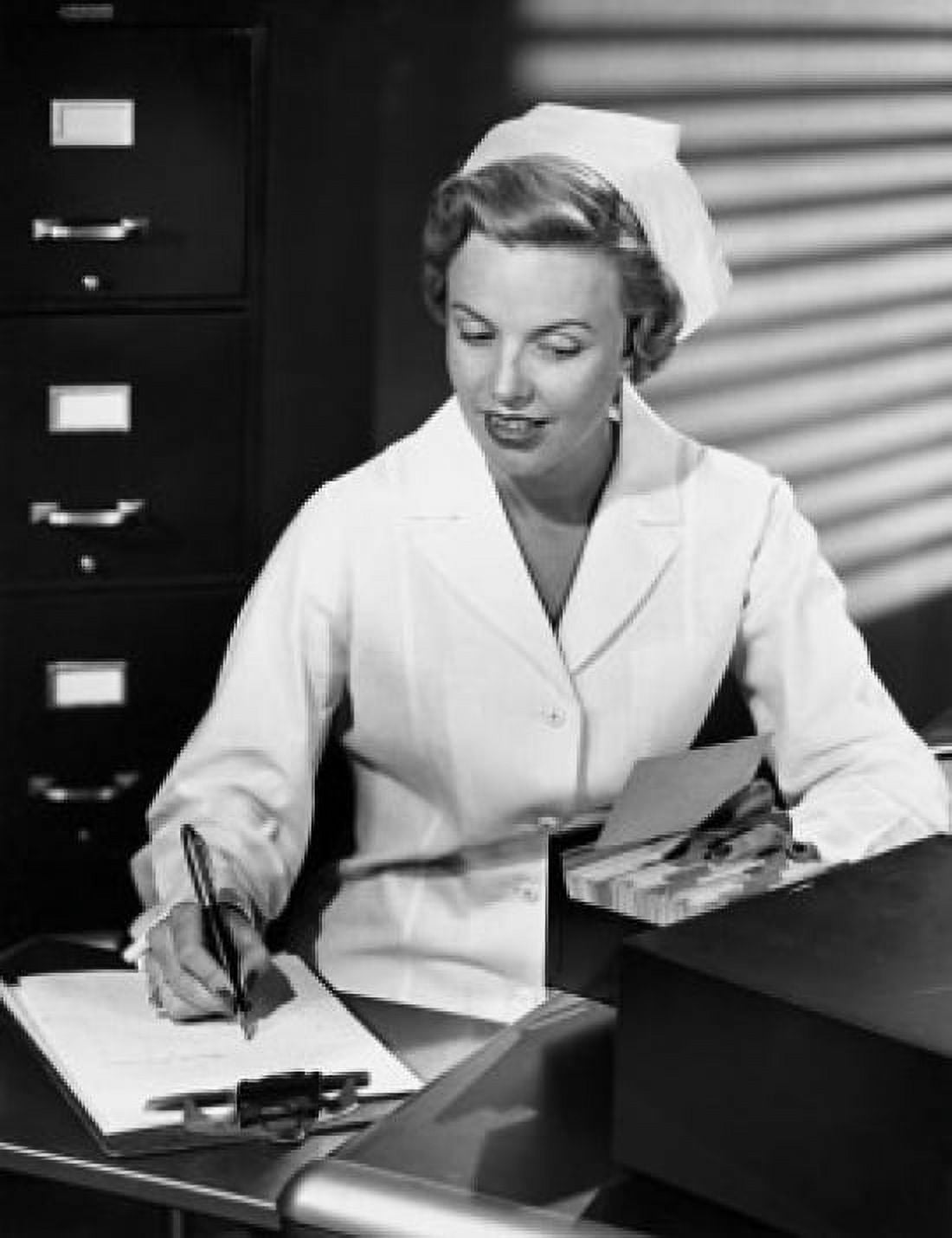 Female nurse writing with a pen on a clipboard Canvas Art - (18 x 24)