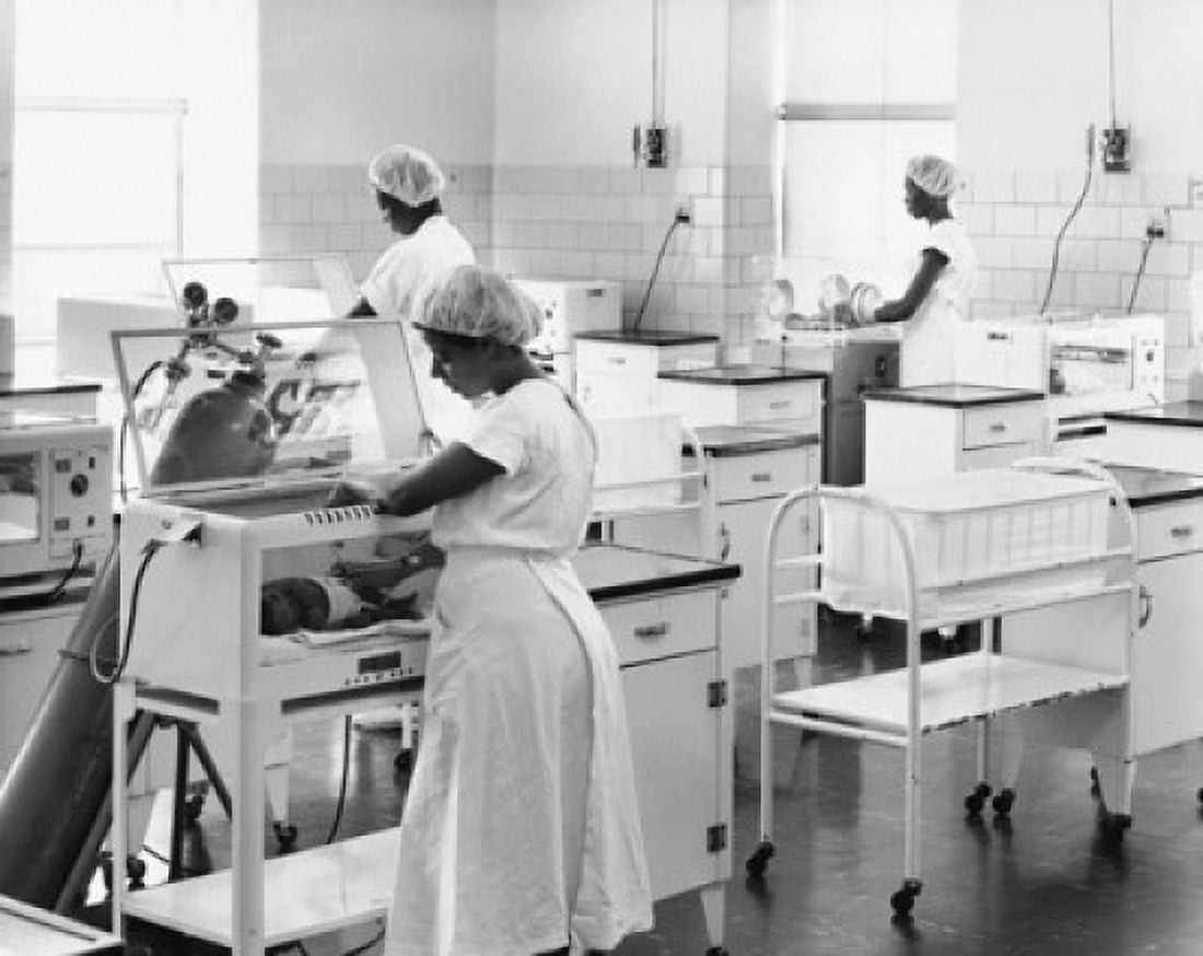 Female nurses examining newborn babies in incubators Canvas Art - (24 x 36)
