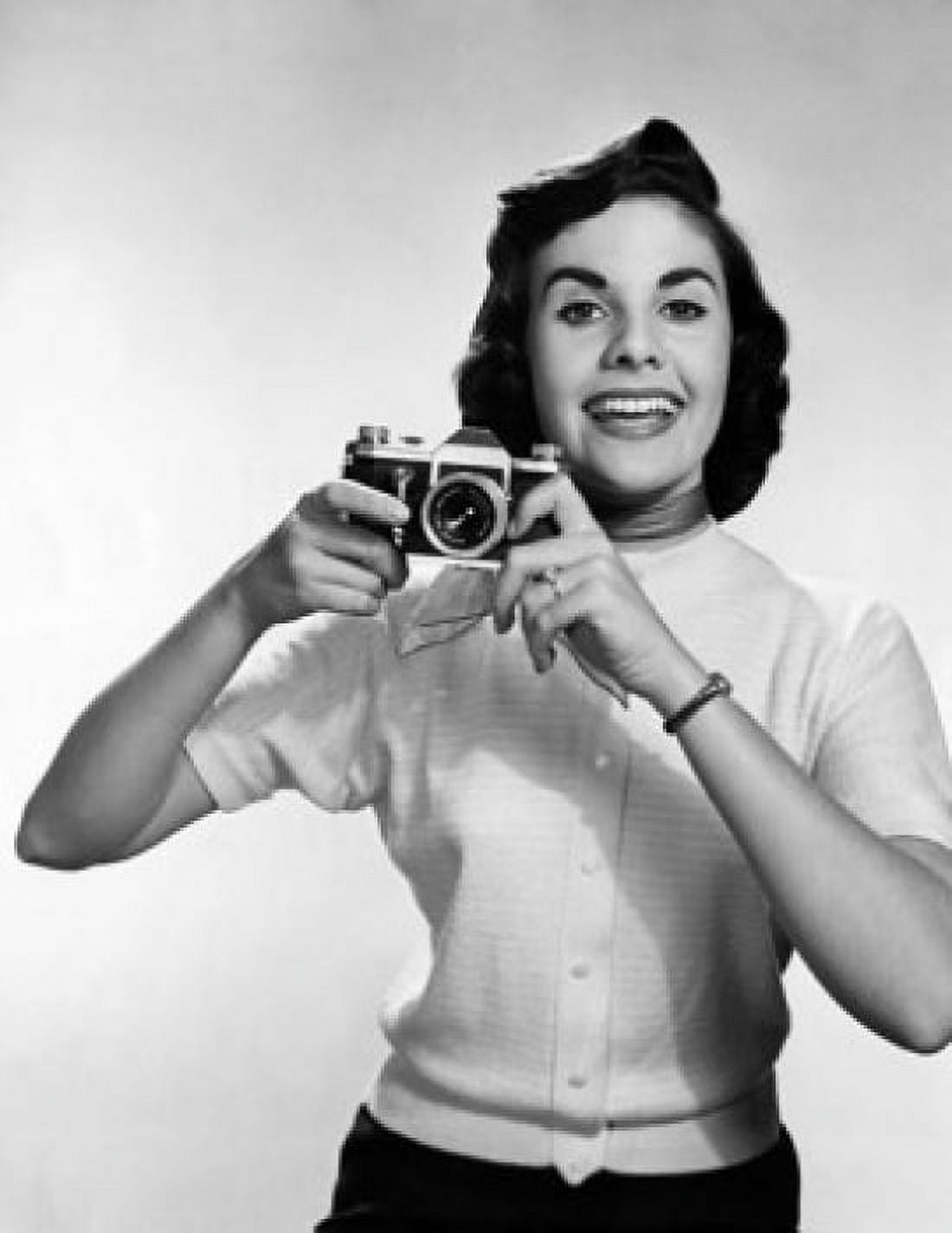 Female photographer holding a camera and smiling Canvas Art - (24 x 36)