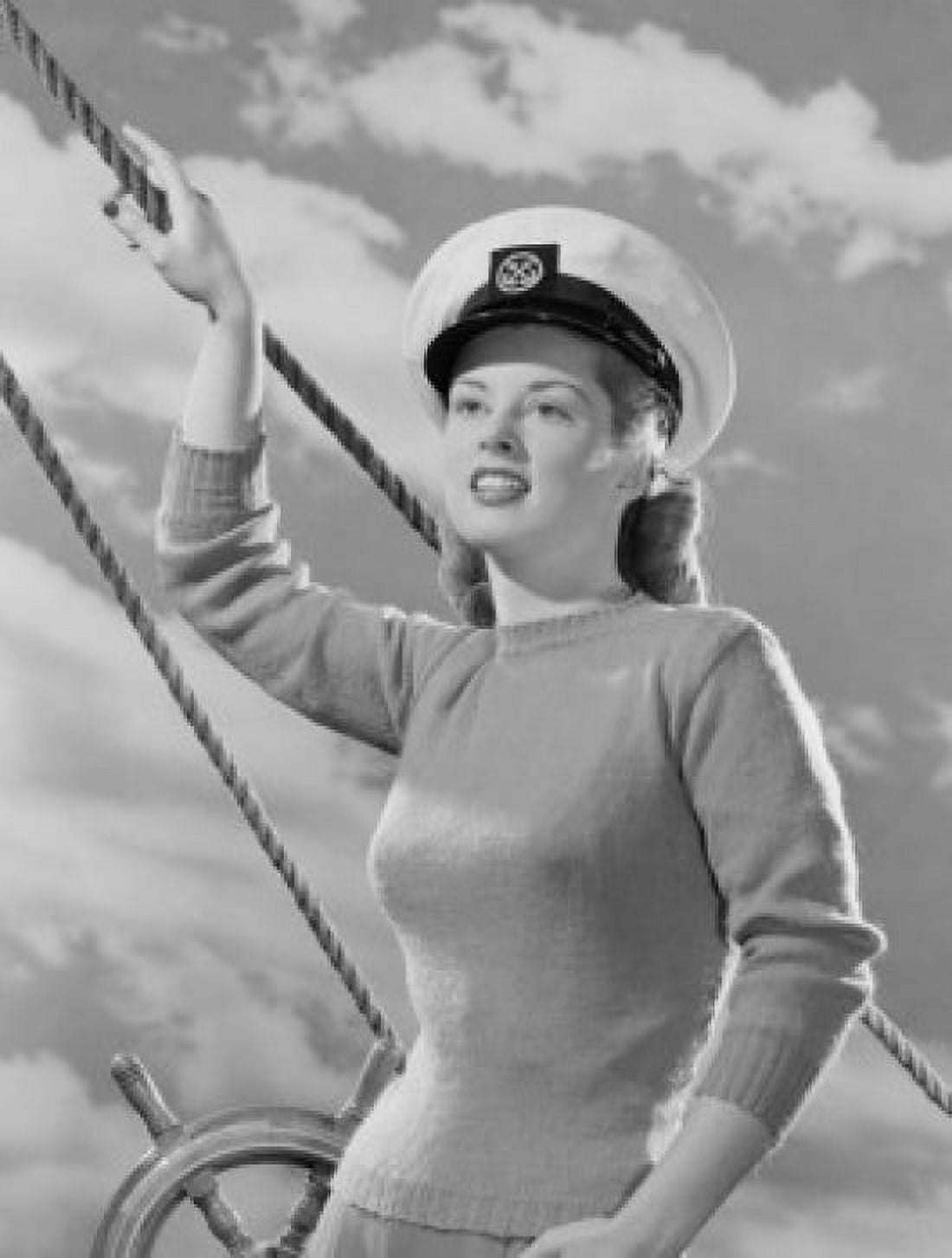 Female sailor holding rope at helm Canvas Art - (24 x 36)
