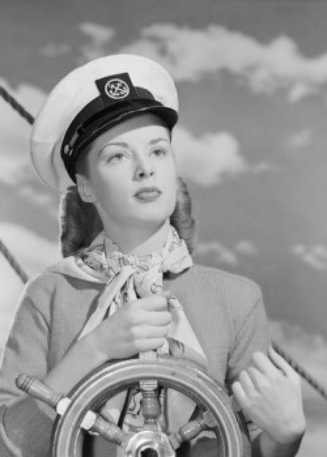 Female sailor holding steering wheel at helm Canvas Art - (18 x 24)