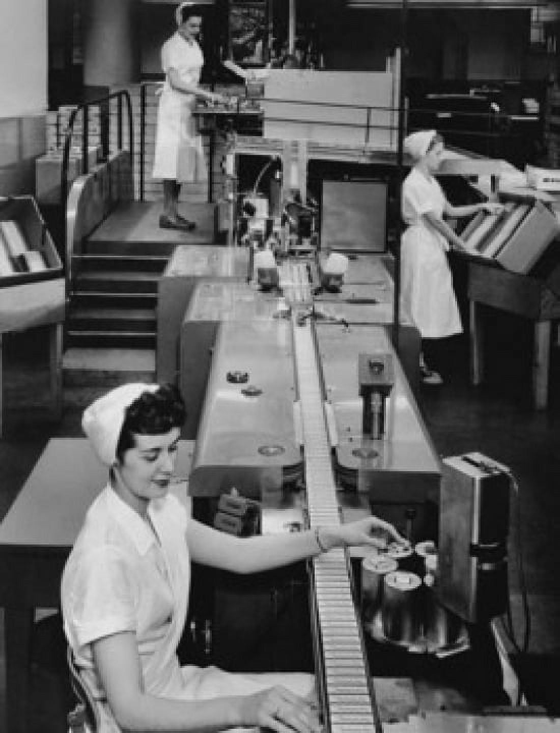 Female workers working on an automatic packaging machine Rochester New York State USA Canvas Art - (18 x 24)