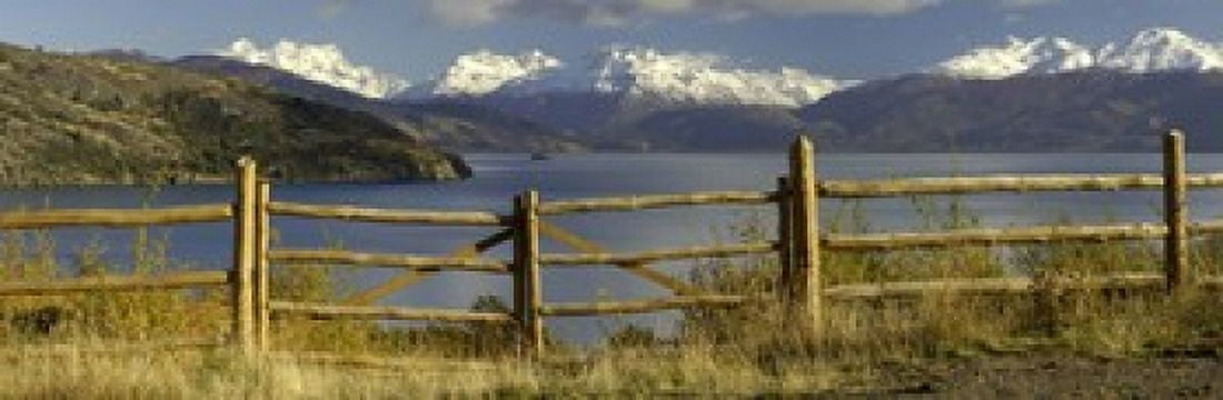 Fence in front of a lake with mountains in the background Lake General Carrera Andes Patagonia Chile Canvas Art - Panoramic Images (18 x 6)
