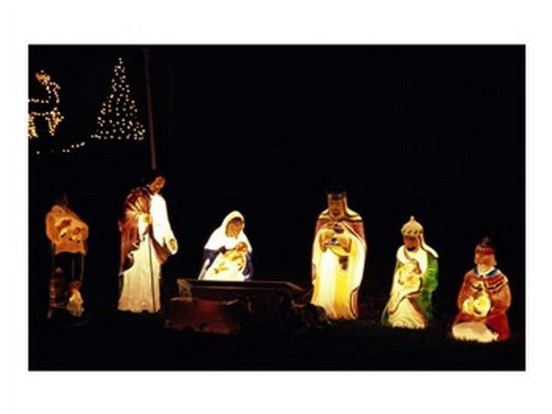 Figurines depicting nativity scene lit up at night Canvas Art - (24 x 18)