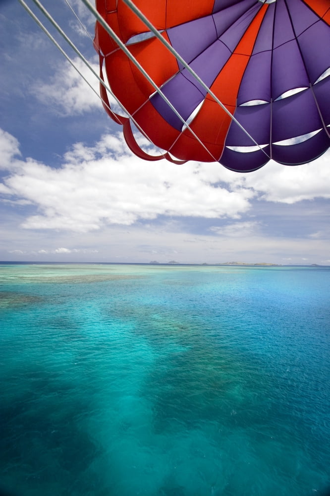 Fiji Colorful parachute over reef and Pacific Ocean Mamanuca Islands Canvas Art - Dave Fleetham Design Pics (22 x 34)