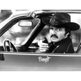 thumbnail image 1 of Film still of Bert Reynolds sitting in a car with walkie talkie Photo Print (8 x 10), 1 of 1