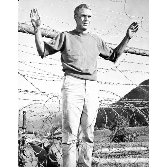 Film still of Steve McQueen with his hands up Photo Print (24 x 30)
