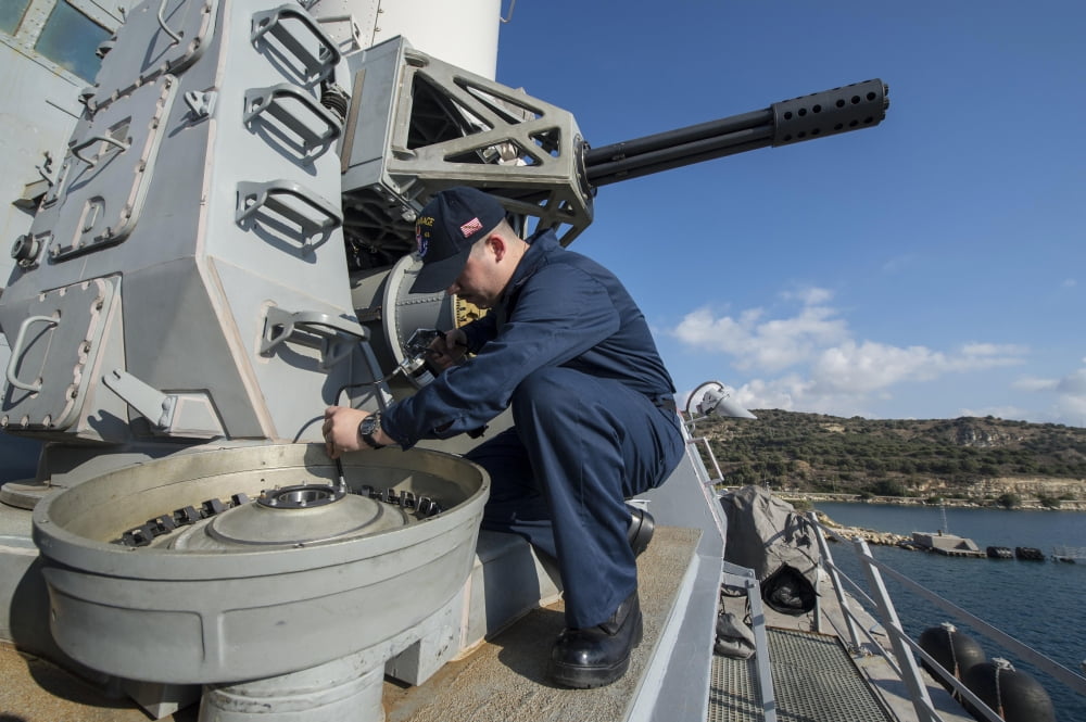 Fire Controlman greases an ammunition drum on a close-in seapons system Canvas Art - Stocktrek Images (34 x 23)