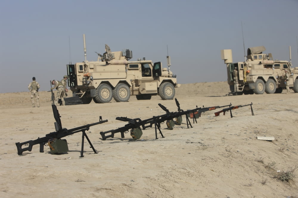 Firearms sit ready on a firing range in Kunduz Afghanistan Canvas Art - Terry MooreStocktrek Images (35 x 24)