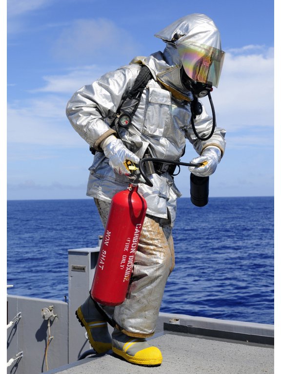 Firefighter carries a CO2 fire extinguisher onto the flight deck of USS Denver Canvas Art - Stocktrek Images (24 x 34)