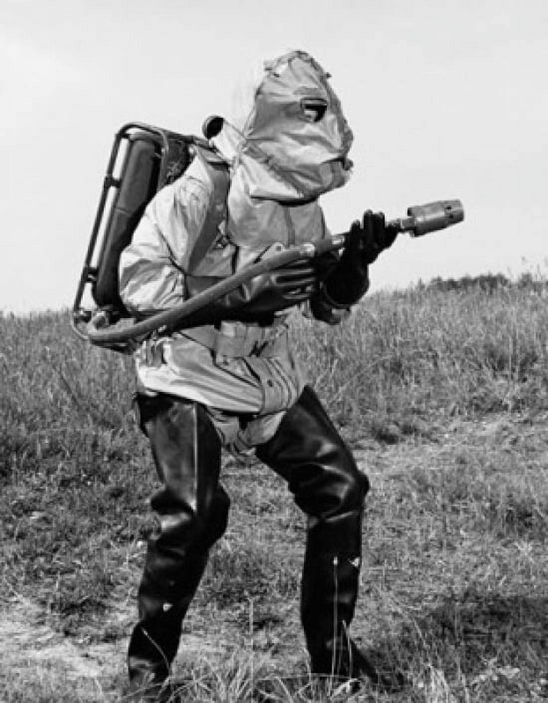 Firefighter wearing a fire protection suit standing in a field Canvas Art - (18 x 24)