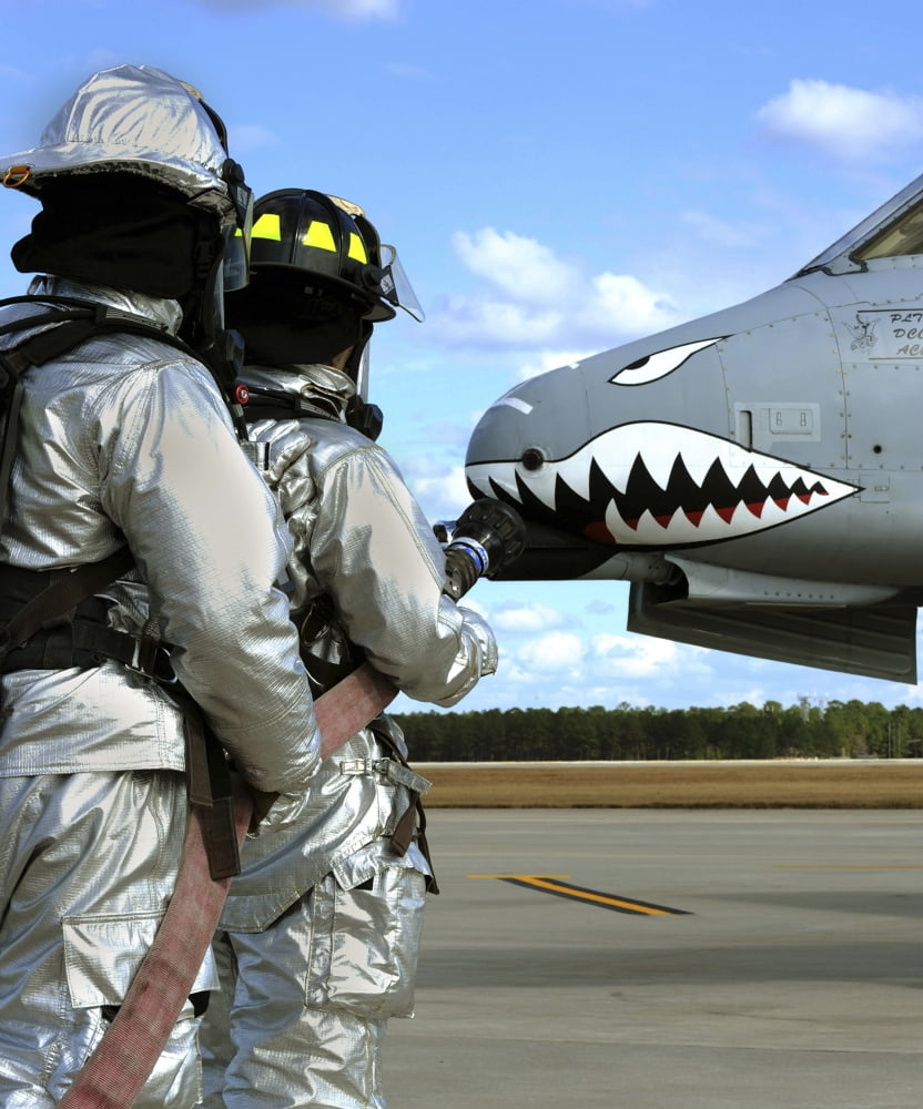 Firefighters deploy a fire hose during a drill at Moody Air Force Base Canvas Art - Stocktrek Images (26 x 31)