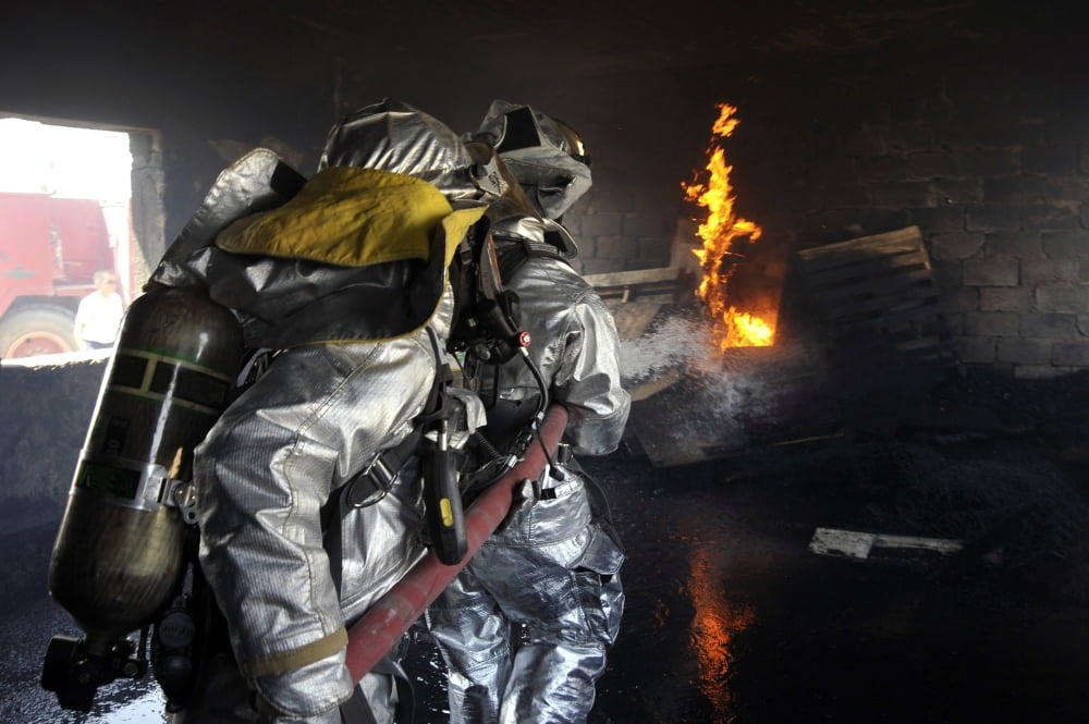 Firefighters extinguish a fire in a training room during live burn training Canvas Art - Stocktrek Images (34 x 23)