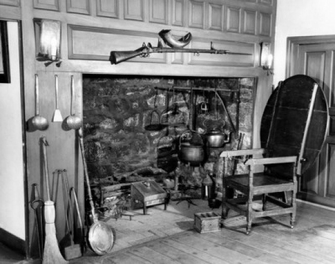 Fireplace tools and an armchair in room with fireplace Canvas Art - (24 x 36)