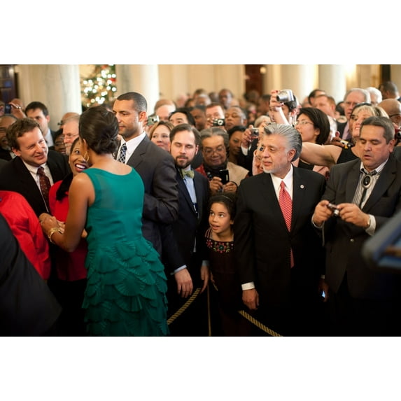 First Lady Michelle Obama Greets Guests In The Grand Foyer Of The White House During A Holiday Party. She Wears A Jason Wu Emerald Green Cocktail Dress With Layered Fan Detailing In The Skirt. Dec. 15