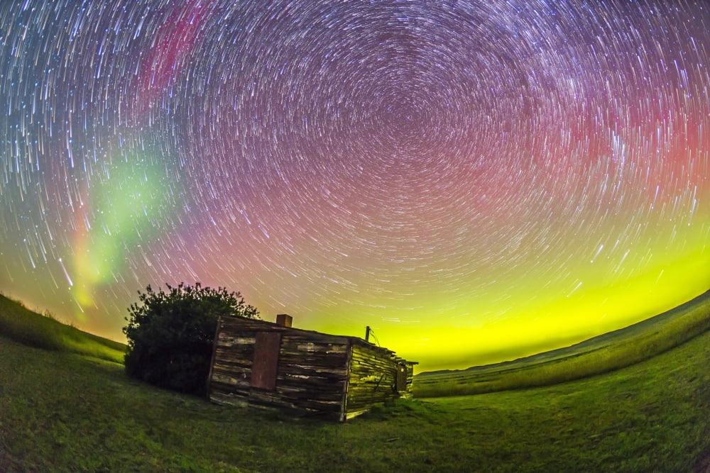 Fish-eye lens composite of aurora and circumpolar star trails above ranch in Canada Canvas Art - Alan DyerStocktrek Images (17 x 12)