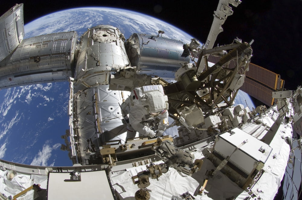 Fish-eye lens view of an astronaut during a spacewalk Canvas Art - Stocktrek Images (35 x 23)