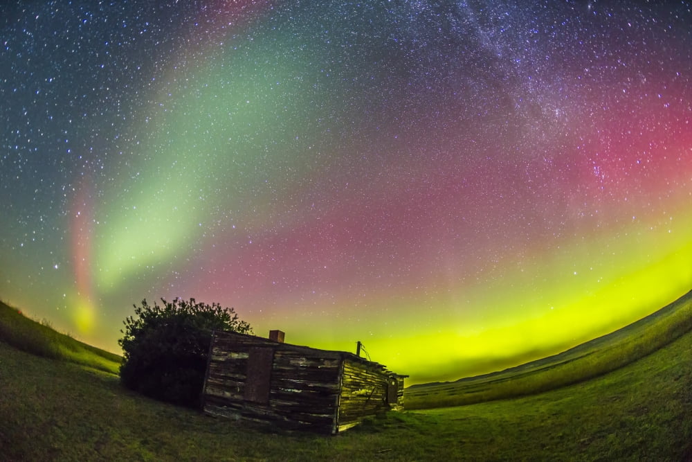Fish-eye lens view of the northern lights above an old ranch in Canada Canvas Art - Alan DyerStocktrek Images (34 x 23)