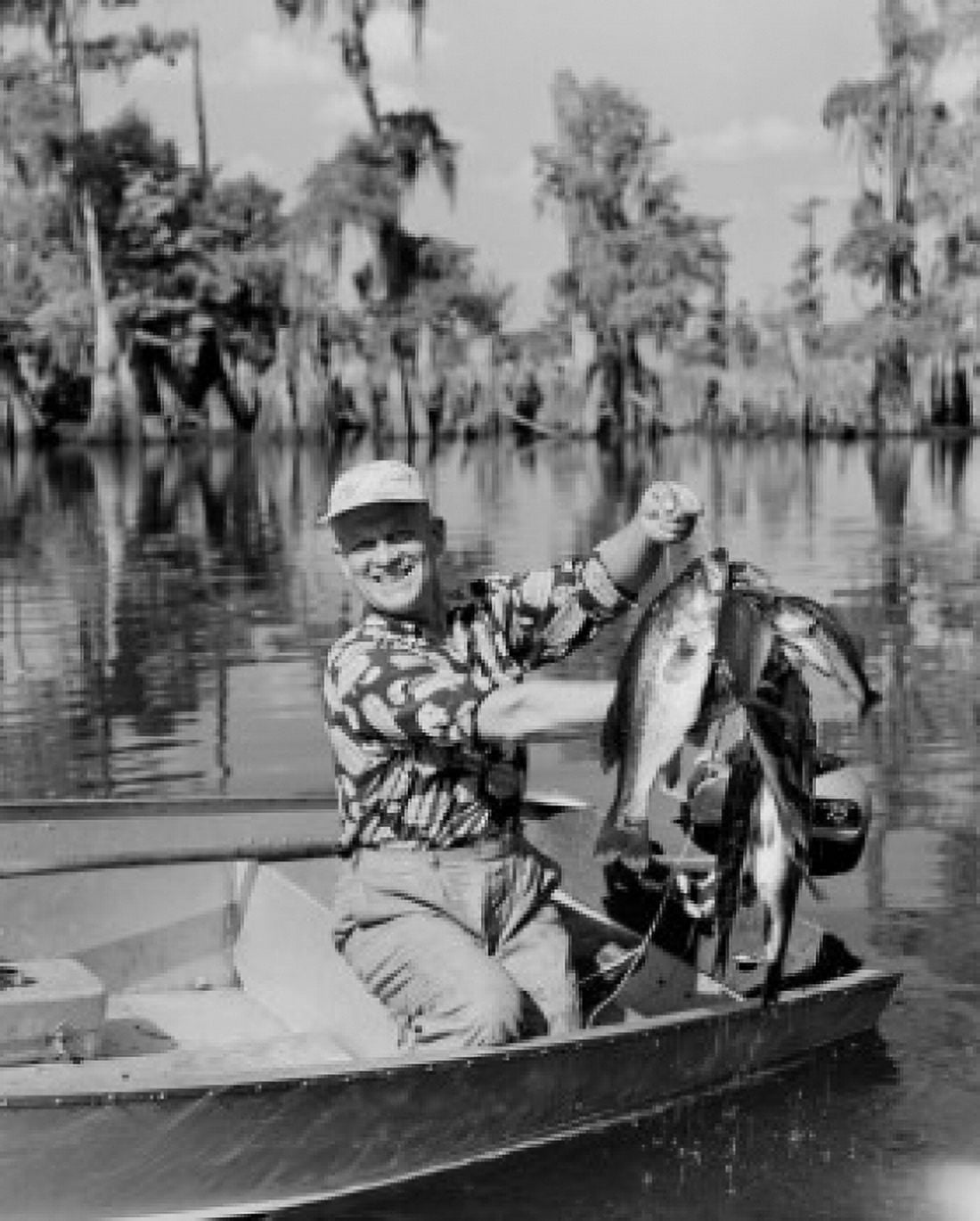 Fisherman holding catch of Black Bass Canvas Art - (24 x 36)
