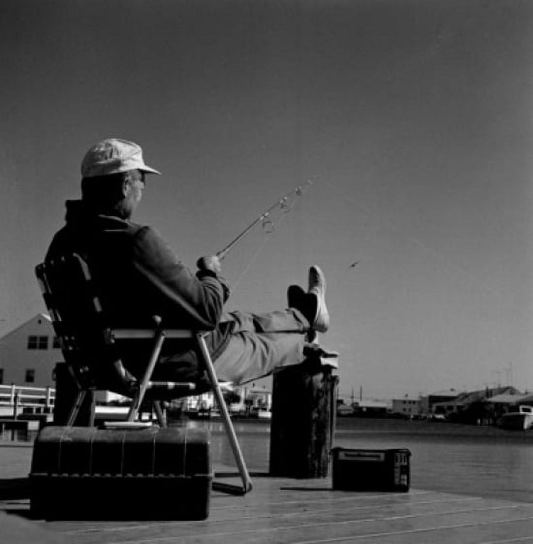 Fisherman sitting in chair at the edge of water Canvas Art - (18 x 24)