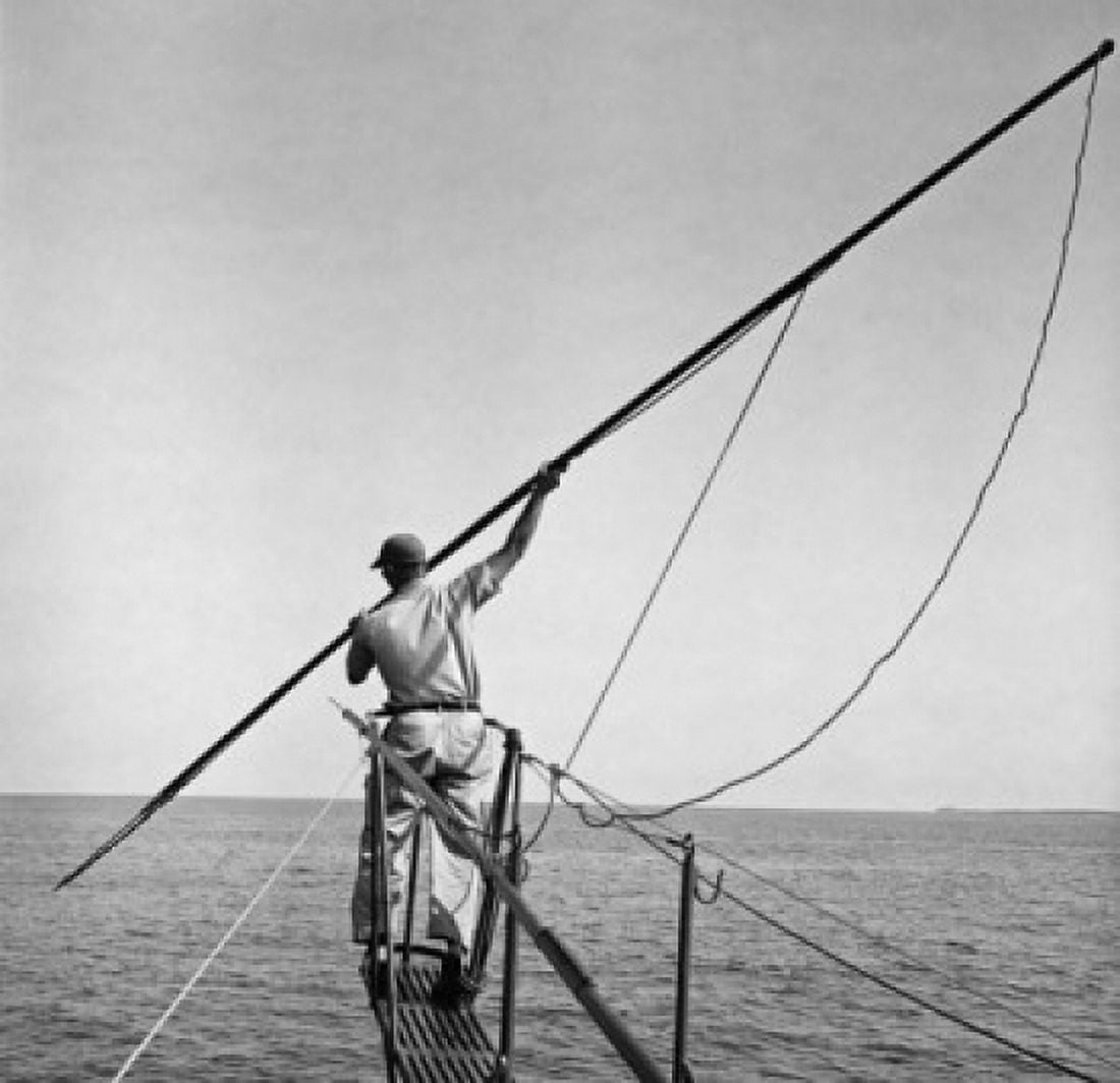 Fisherman using a harpoon to catch fish Canvas Art - (18 x 24)