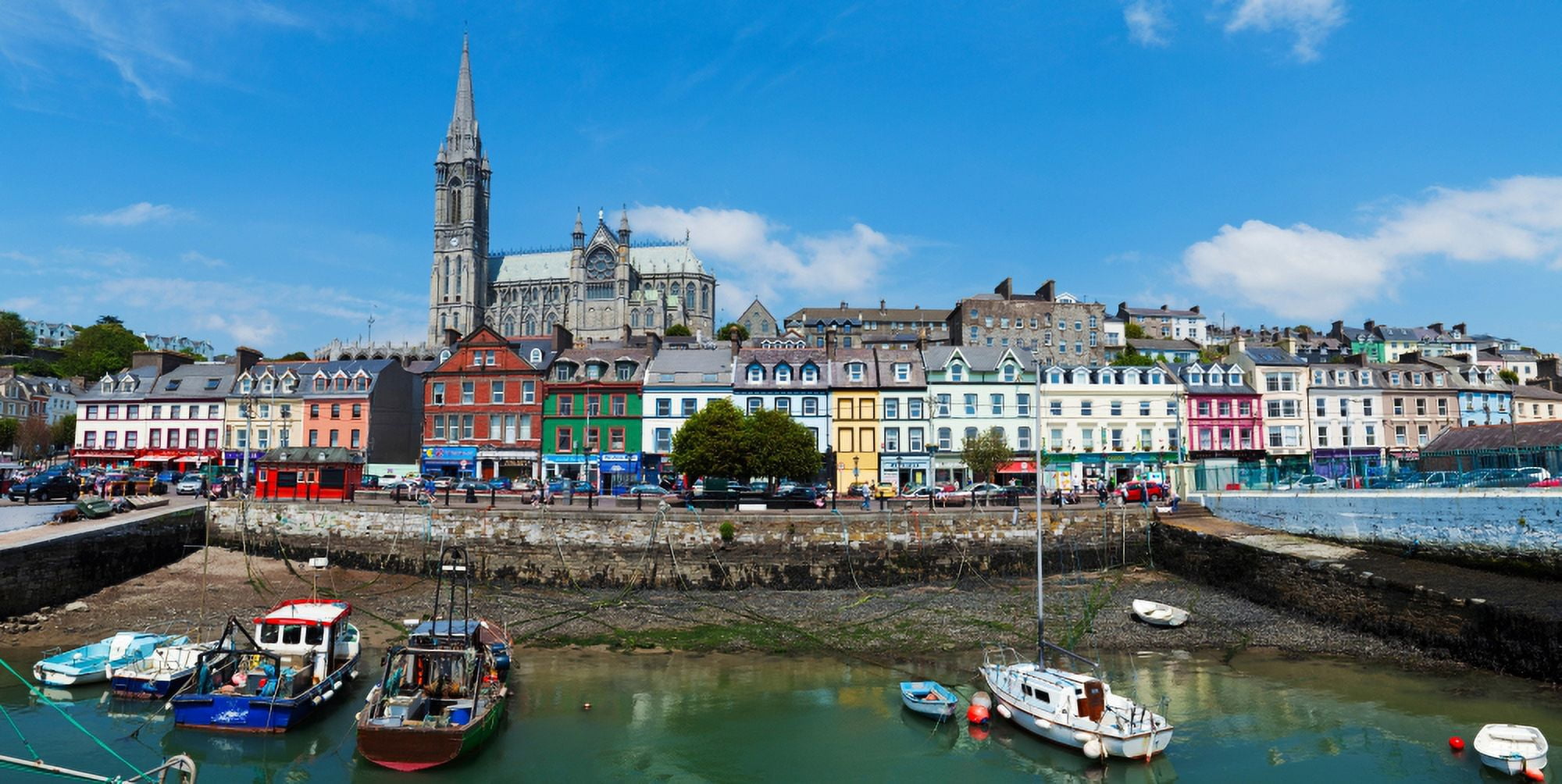Fishing boats at a harbor with a cathedral in the background St Colmans Cathedral Cobh County Cork Republic Of Ireland Canvas Art - Panoramic Images (27 x 9)