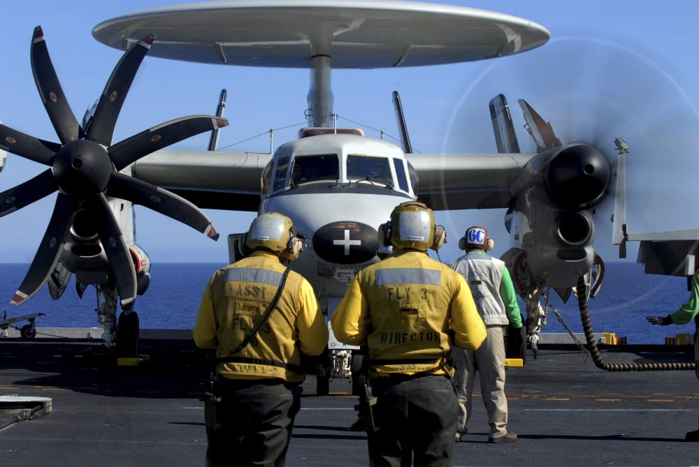 Flight deck directors watch as pilots of an E-2C Hawkeye start-up their engines Canvas Art - Stocktrek Images (34 x 23)