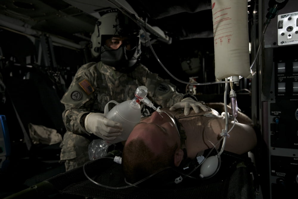 Flight medic looks after a mock patient in a UH-60 Black Hawk helicopter Canvas Art - Terry MooreStocktrek Images (18 x 12)