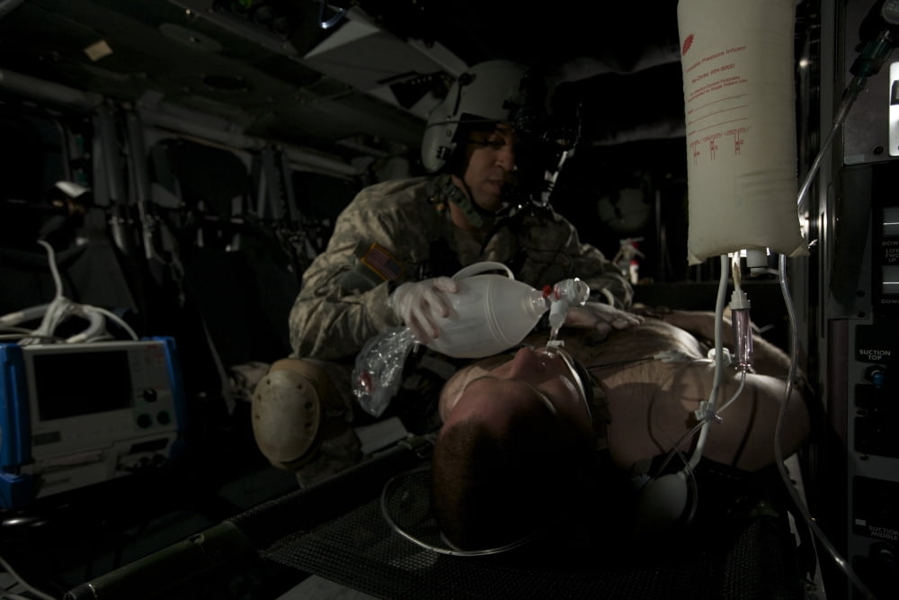 Flight medic looks after a mock patient in a UH-60 Black Hawk helicopter Canvas Art - Terry MooreStocktrek Images (18 x 12)