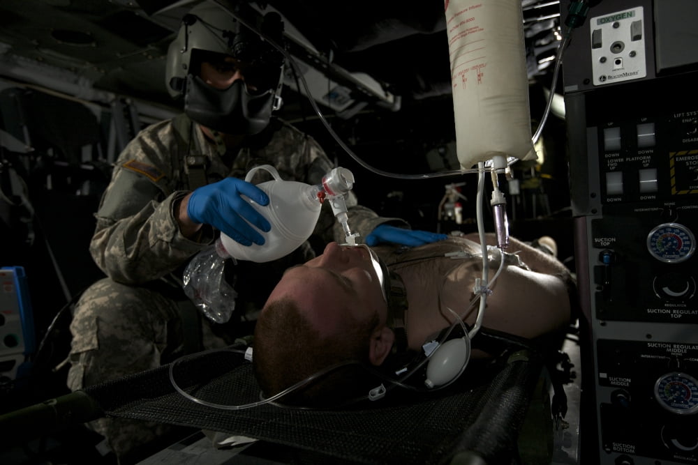 Flight medic looks after a mock patient in a UH-60 Black Hawk helicopter Canvas Art - Terry MooreStocktrek Images (35 x 23)