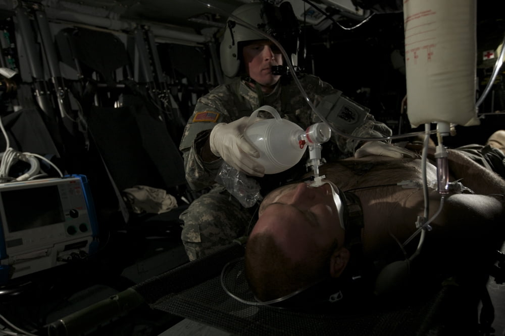 Flight medic looks after a mock patient in a UH-60 Black Hawk helicopter Canvas Art - Terry MooreStocktrek Images (35 x 23)