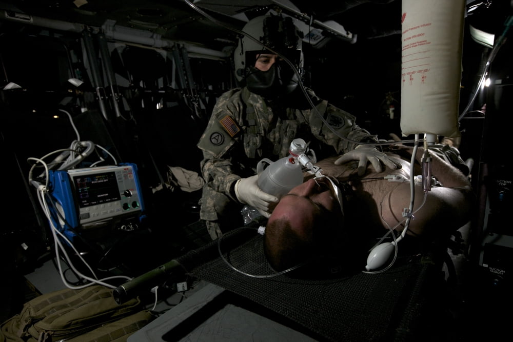 Flight medic looks after a mock patient in a UH-60 Black Hawk helicopter Canvas Art - Terry MooreStocktrek Images (35 x 23)