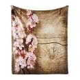 thumbnail image 1 of Floral Soft Flannel Fleece Throw Blanket, Spring Blossom Orchard Featured Plant on Wooden Board Background Image, Cozy Plush for Indoor and Outdoor Use, 50" x 60", Sand Brown Pale Pink, by Ambesonne, 1 of 5