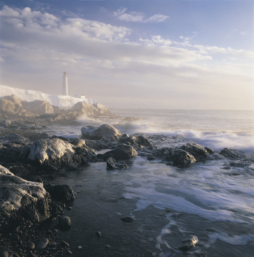 Fog And Rocky Shoreline In Winter With Cap Des Rosiers Lighthouse Northeast Gasp Canvas Art - Claude Bouchard Design Pics (24 x 24)