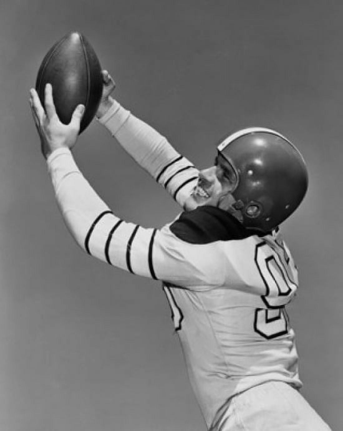 Football player catching a football Canvas Art - (18 x 24)
