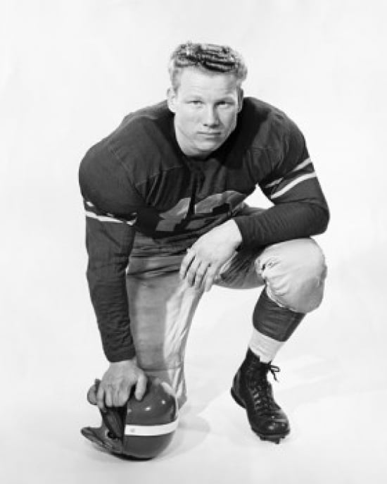 Football player kneeling and holding a football helmet Canvas Art - (18 x 24)