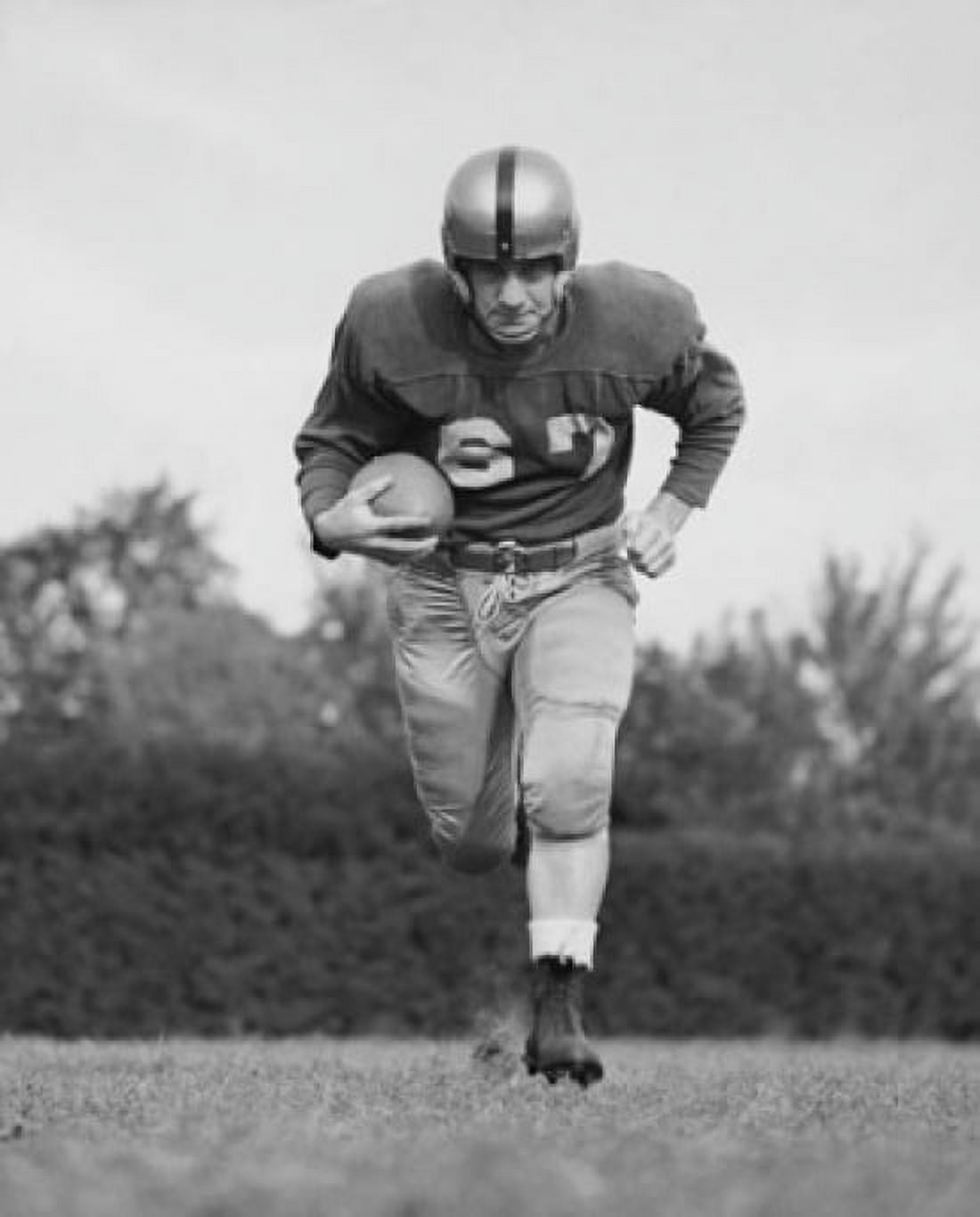 Football player running with a football on a football field Canvas Art - (18 x 24)