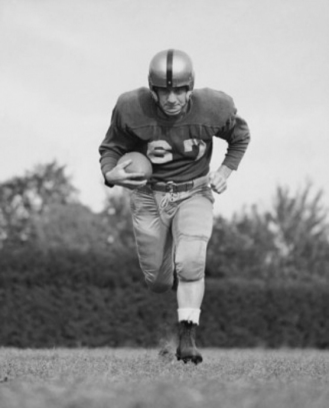Football player running with a football on a football field Canvas Art - (24 x 36)